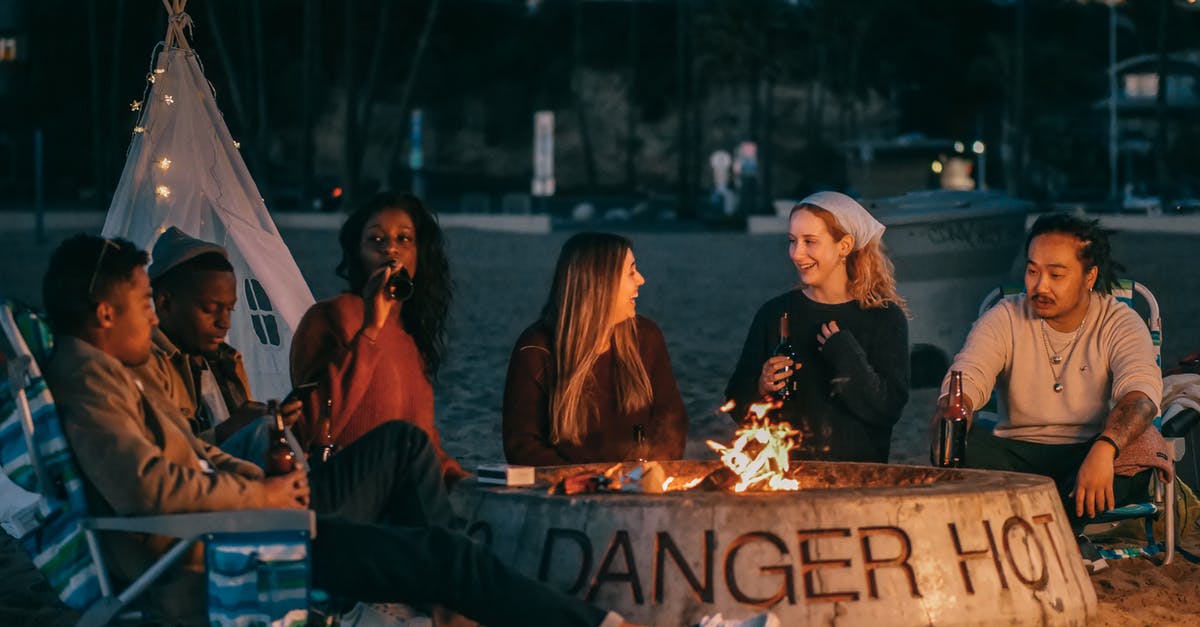 How to get a layover longer than a few hours? - Group of Friends Sitting in Front of Fire Pit