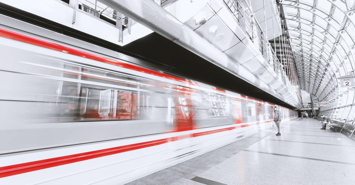 How to get from Gdańsk ferry terminal to Gdańsk railway station? - Blurred Motion of Illuminated Railroad Station in City