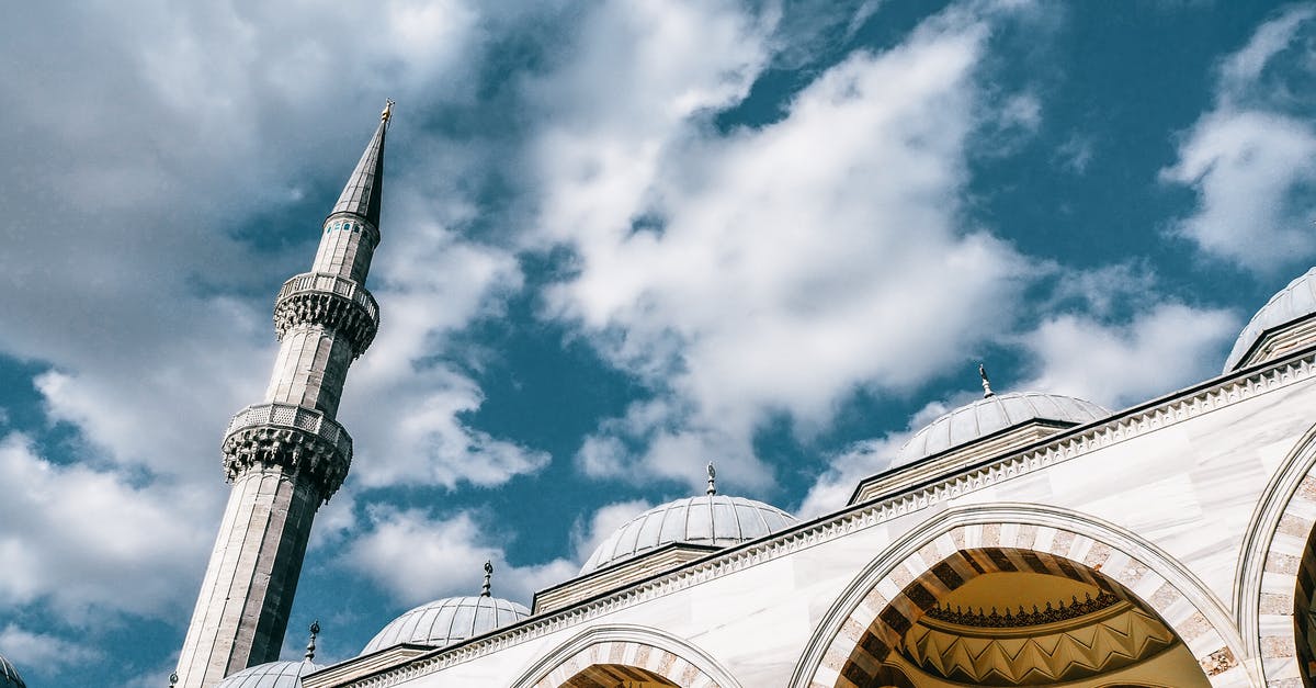 How to get from Istanbul to Ankara by land? - From below of famous mosque with domes and  arched passages under blue cloudy sky