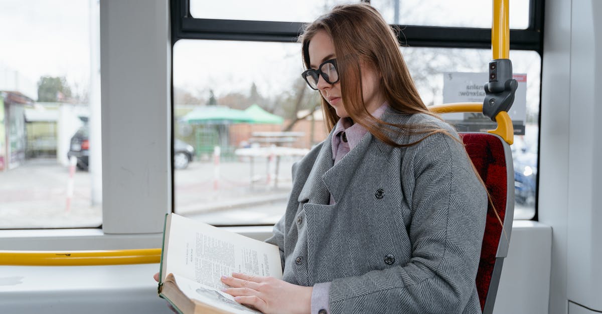 How to get off a London bus when sitting on the top deck? - Woman in Gray Coat Sitting in the Bus while Reading a Book How to get off a London bus when sitting on the top deck? - Woman in Gray Coat Sitting in the Bus while Reading a Book