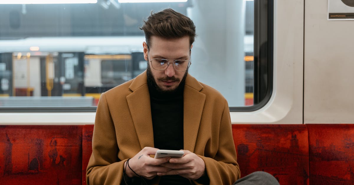 How to get off a London bus when sitting on the top deck? - Man in Brown Coat Sitting on Red Seat while Texting How to get off a London bus when sitting on the top deck? - Man in Brown Coat Sitting on Red Seat while Texting