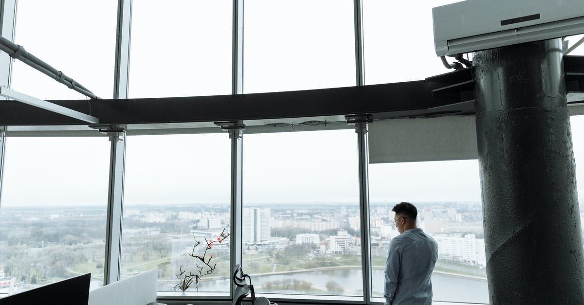 How to get to Antarctica without using a travel company - Man in White Dress Shirt Standing Near Window