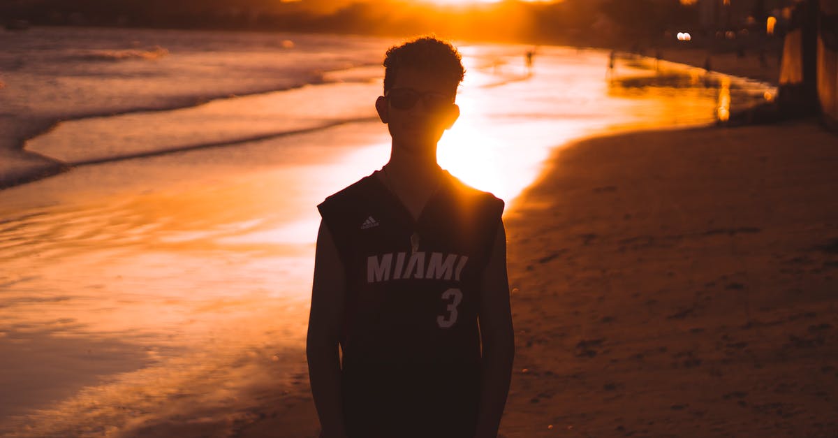 How to handle a 12 hour layover in Miami - Man in Black vest Standing on Beach during Sunset