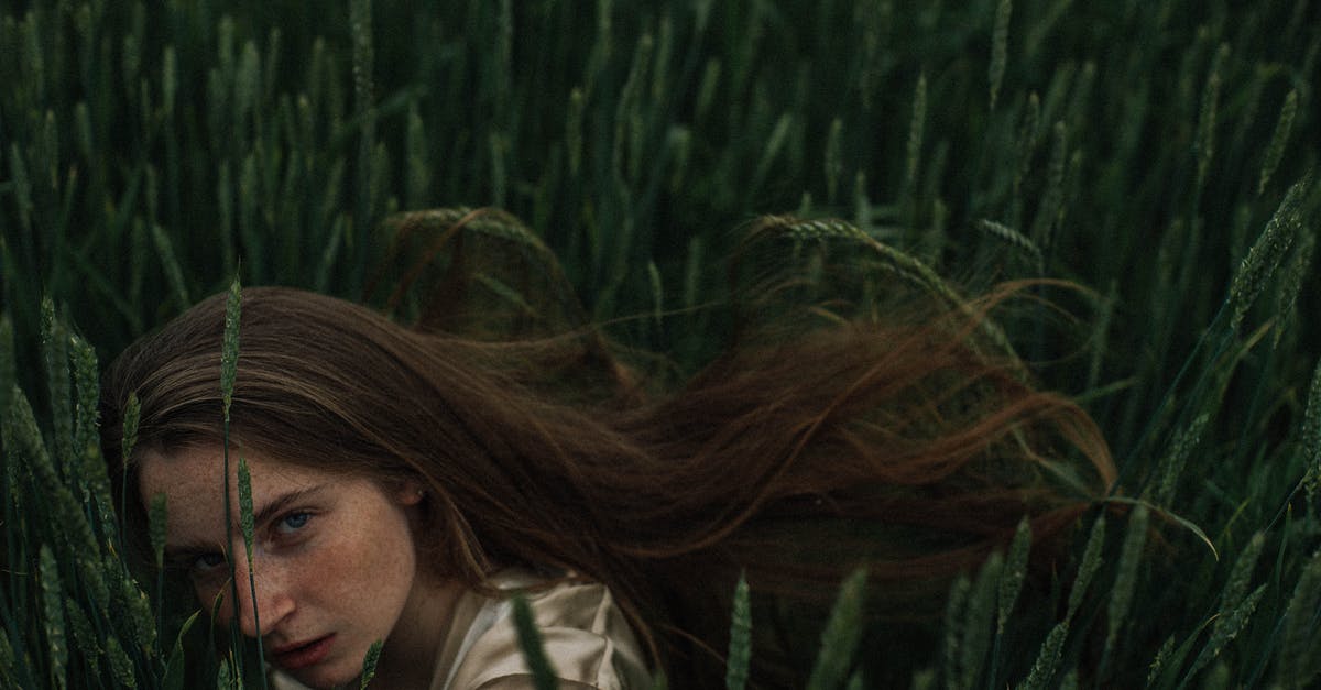 How to hide your bodily odors after a long flight? - Blond Woman with Freckled Face Hiding in Crop Field