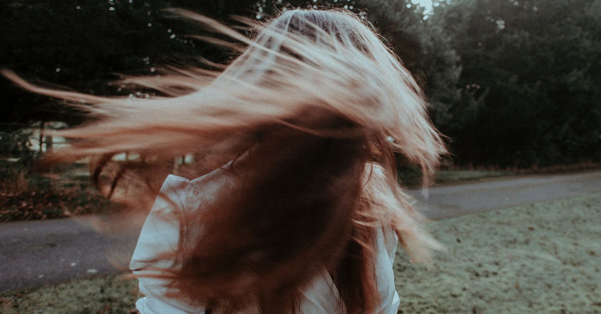 How to hide your bodily odors after a long flight? - Woman with flying hair in summer park