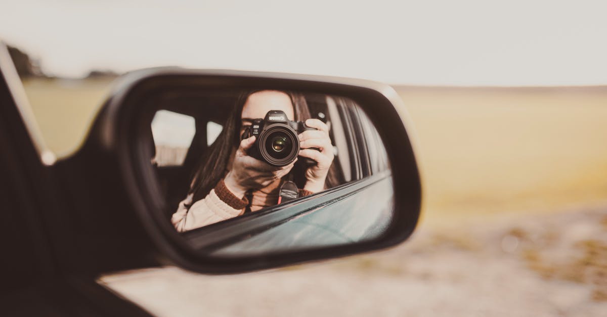 How to insure professional equipment while traveling - Unrecognizable female photographer taking photos and reflecting in rear window