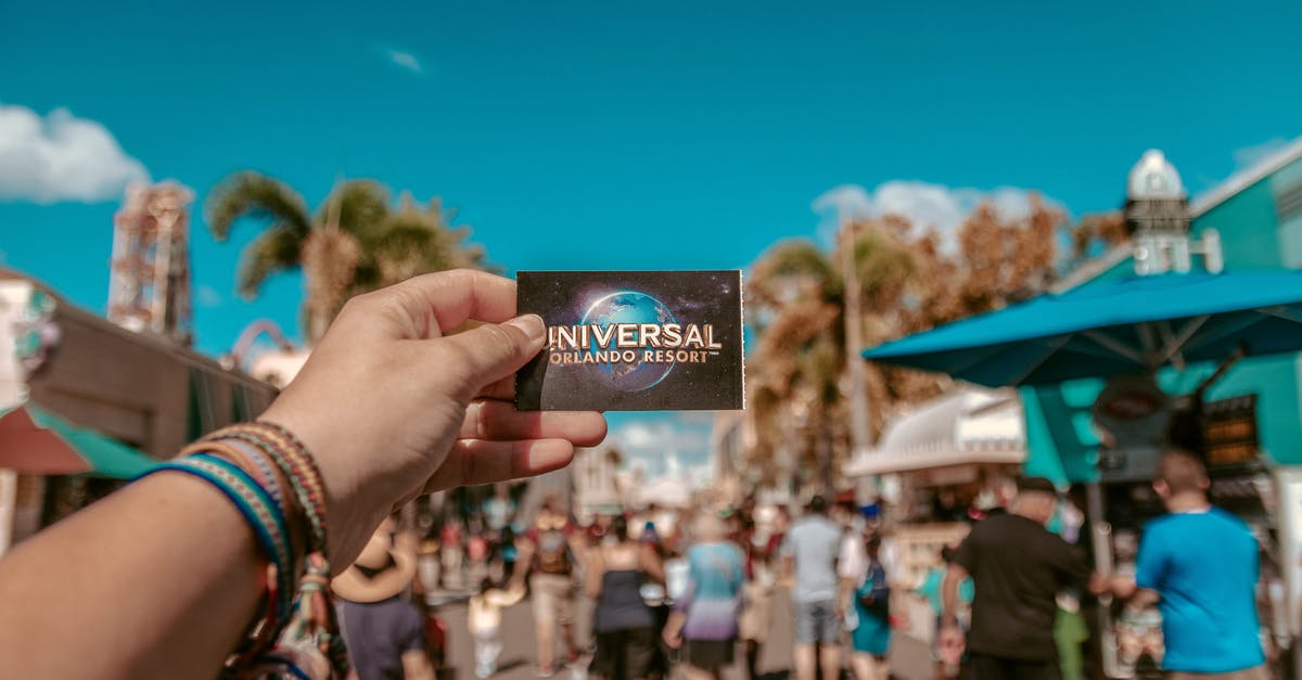 How to know if a Delta ticket is refundable? - Person Holding Universal Studios Ticket