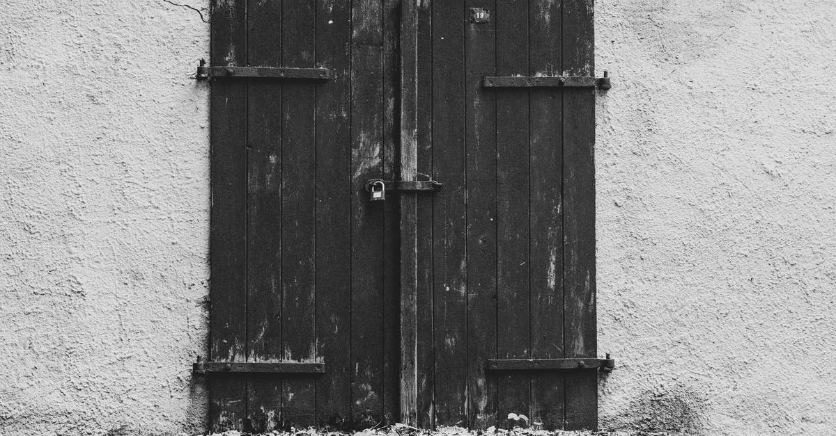 How to lock a backpack? - Grayscale Photo of Wooden Door with Lock