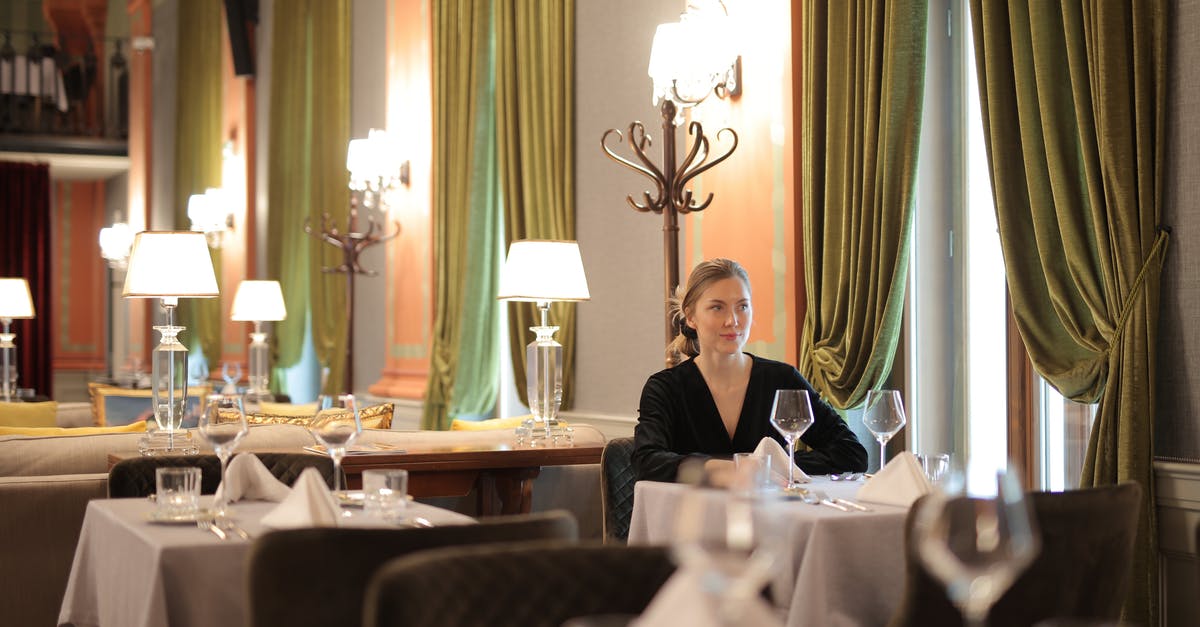 How to make dining alone less awkward? - Woman In A Restaurant Sitting Alone