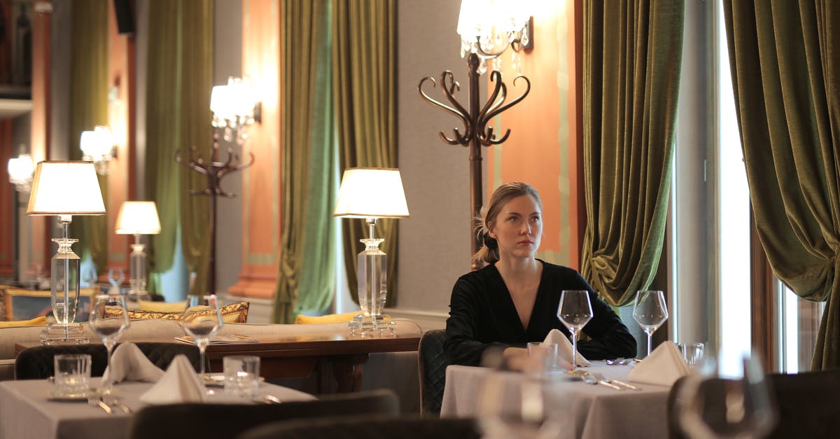 How to make dining alone less awkward? - Woman Sitting Alone In A Restaurant