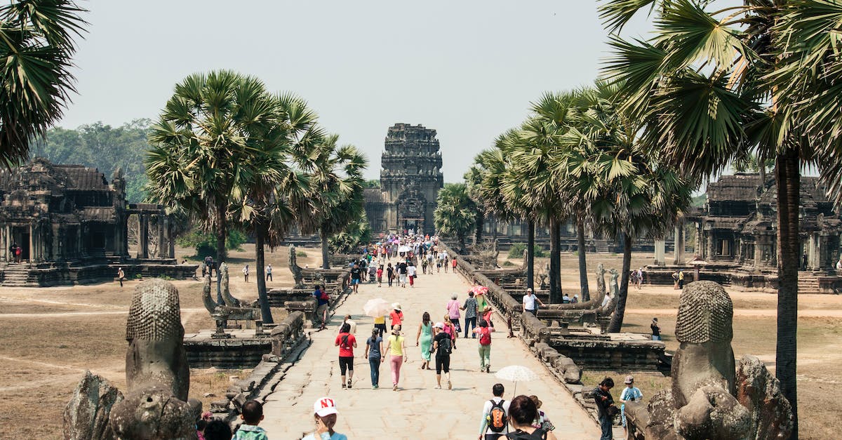 How to obtain a Cambodia tourist visa in Bangkok? - Crowd of people strolling along paved walkway of ancient Angkor Wat in Cambodia