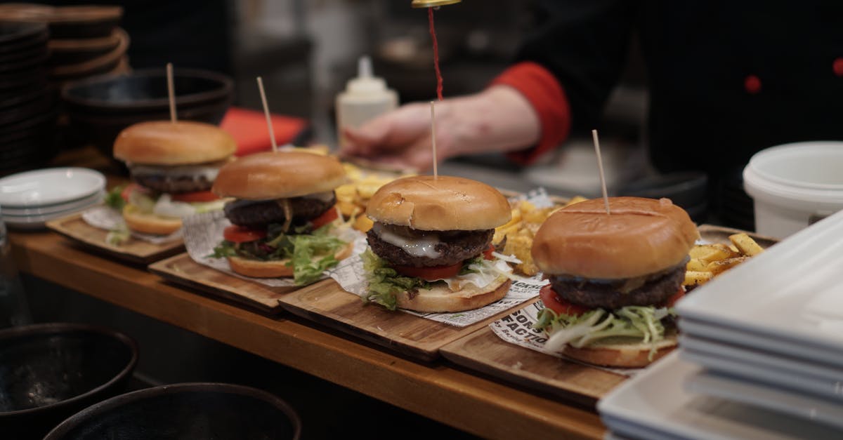 How to order an autonomous taxi in Dubai? - Burger With Lettuce and Tomato on Brown Wooden Tray