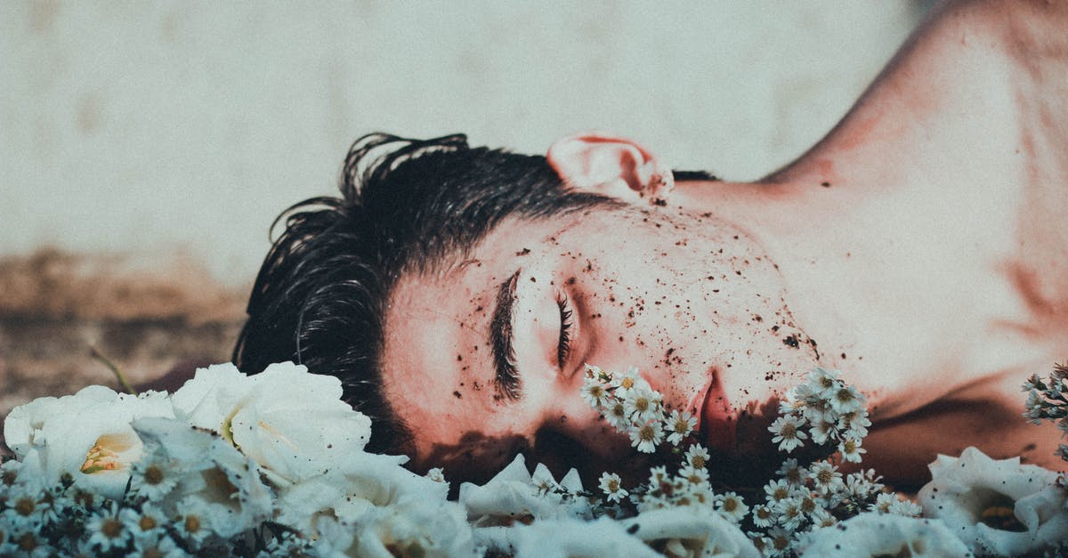 How to overcome depression when relocating? [closed] - Man Lying on White Flowers