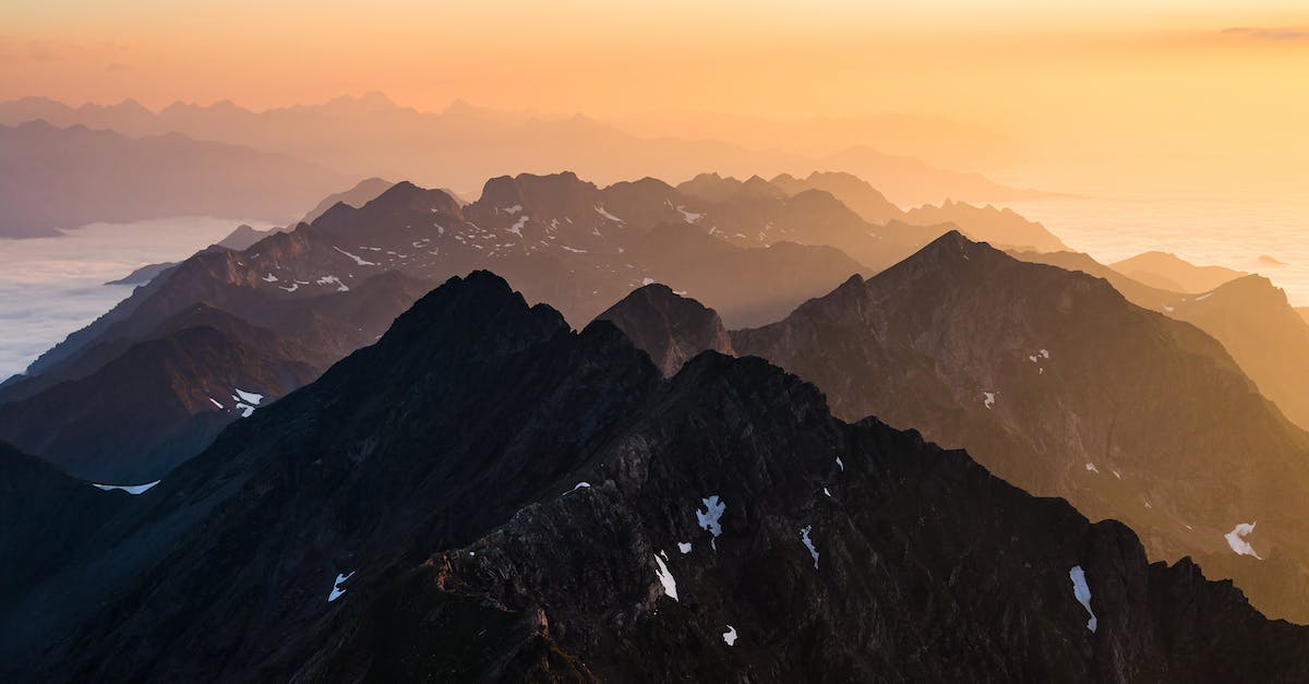 How to overcome the language barrier when visiting France and Spain? - Drone Shot of Rocky Mountains