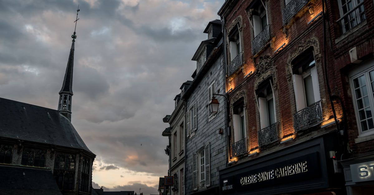 How to overcome the language barrier when visiting France and Spain? - Brown and White Concrete Building Under White Clouds