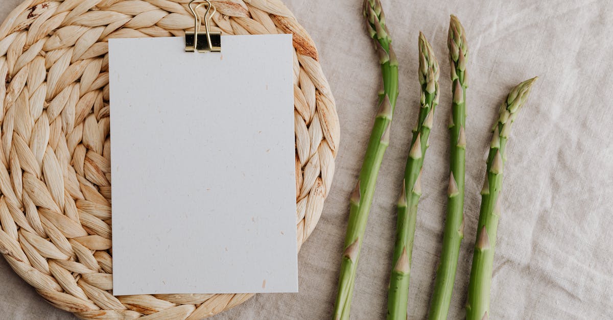 How to pass a Green Card through immigration to someone arriving to the US from abroad? - From above of four fresh green asparagus sprouts and blank sheet of paper over round wicker placemat laid on white tablecloth How to pass a Green Card through immigration to someone arriving to the US from abroad? - From above of four fresh green asparagus sprouts and blank sheet of paper over round wicker placemat laid on white tablecloth