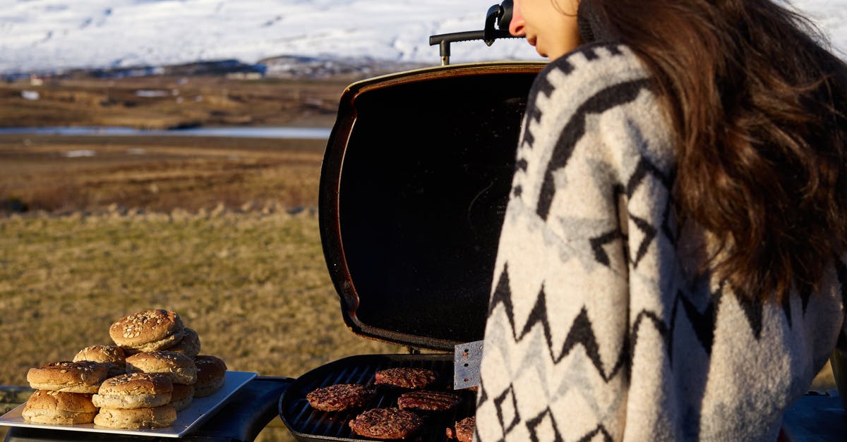 How to prepare for a winter trip to Yellowknife, clothing-wise? - Young woman near portable BBQ in countryside