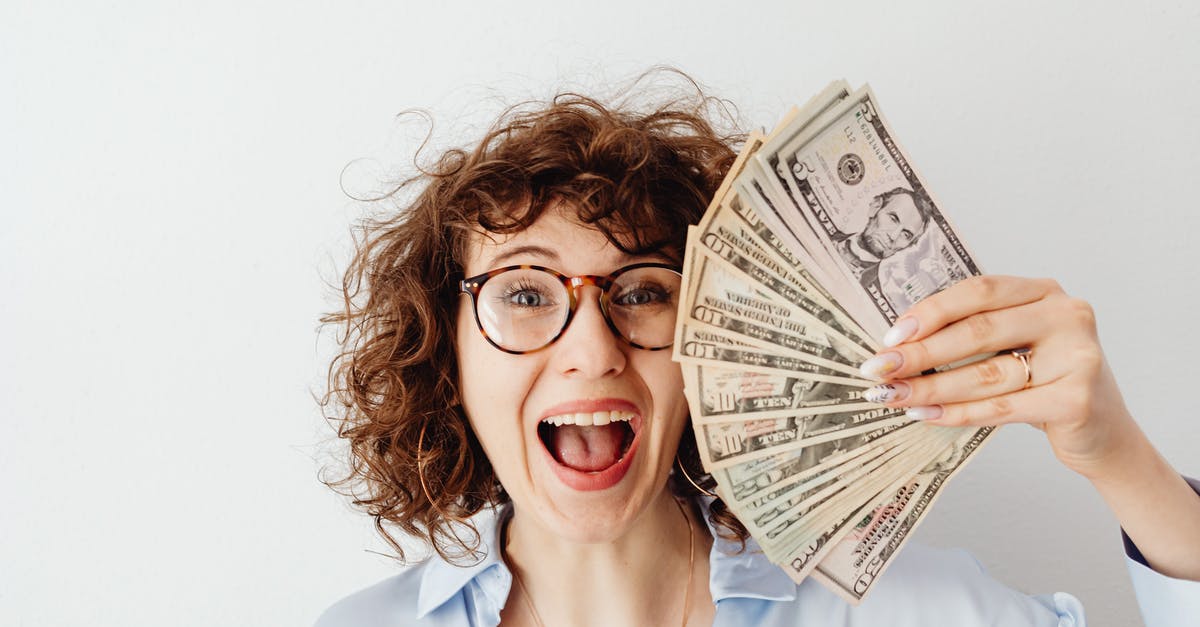 How to prove sufficient funds when entering the US? - Happy Woman in Blue Long Sleeve Blouse Holding Money