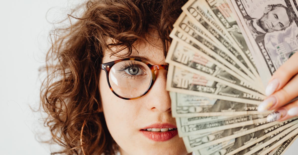 How to prove sufficient funds when entering the US? - Woman in Eyeglasses Covering Her Face with Paper Money