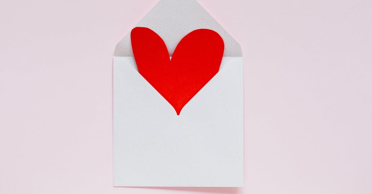 How to reach Dam Square from Schiphol airport? - Open envelope with heart made of colored carton