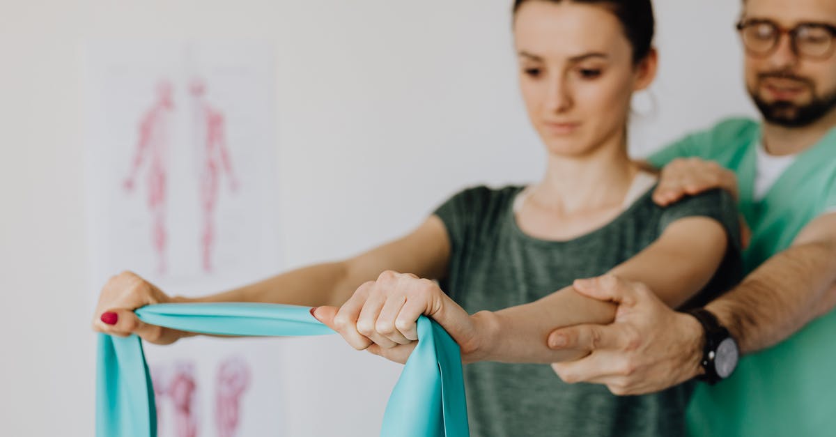 How to reach Treriksröset? - Crop orthopedist checking up female patient with elastic band