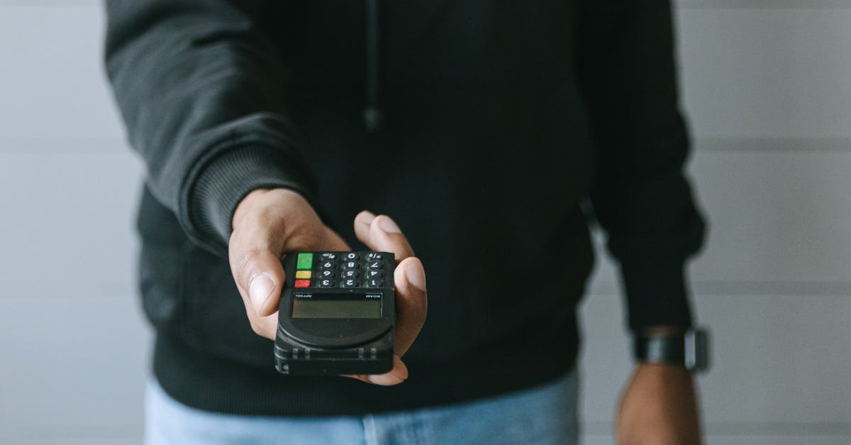 How to receive money abroad, (transfer companies)? - Person in Black Long Sleeve Shirt Holding Black Smartphone