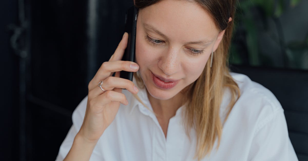 How to request a refund from Condor Airlines without calling them? - Woman in White Dress Shirt Holding Black Smartphone