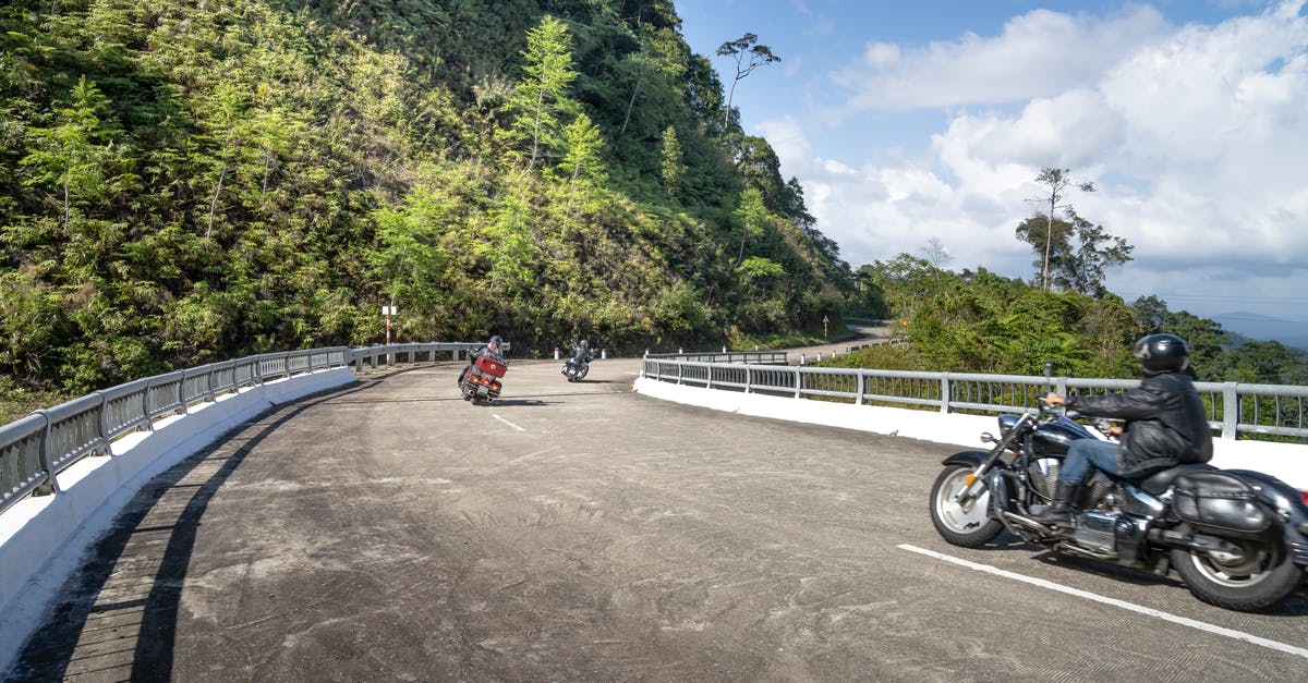 How to safely transport external hard drives during air travel? - Anonymous motorcyclists driving bikes on wavy road in mountains