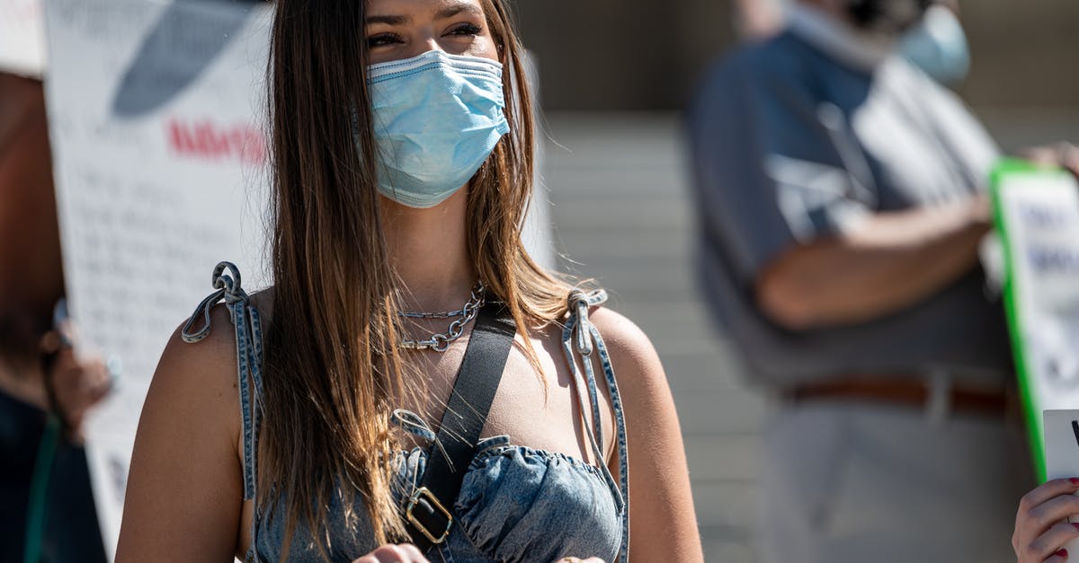 How to safely turn right in Thailand - Young woman in mask protesting on street