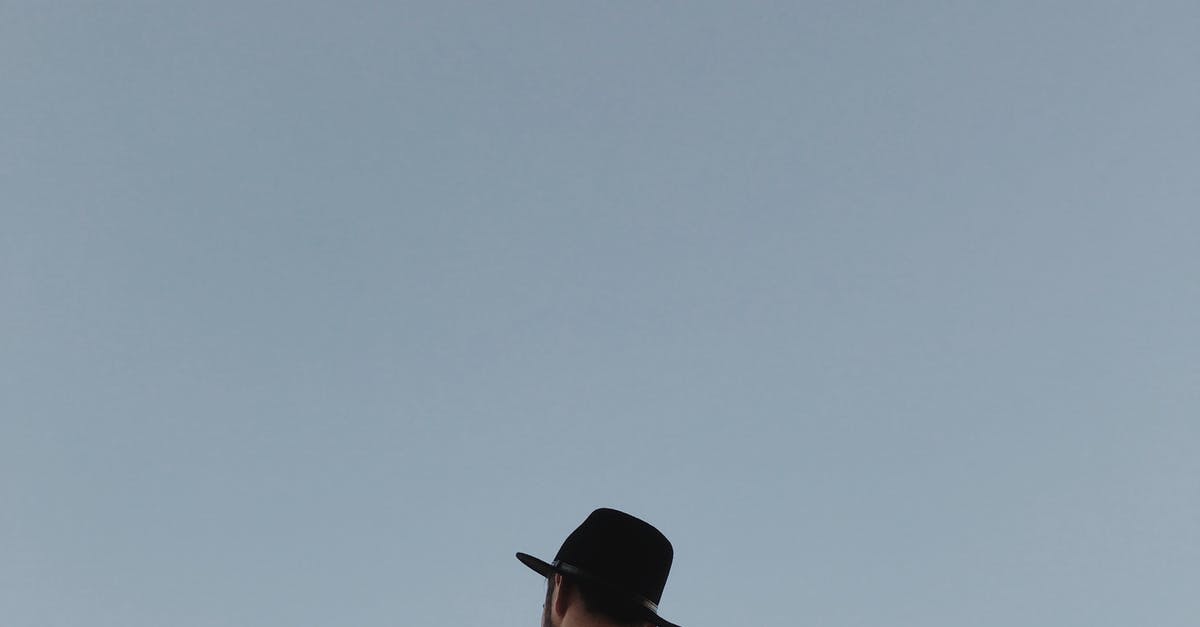 How to select the perfect travel hat [closed] - Faceless unshaven man in hat on blue background