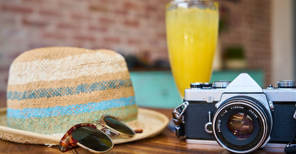 How to select the perfect travel hat [closed] - Gray and Black Dslr Camera Beside Sun Hat and Sunglasses