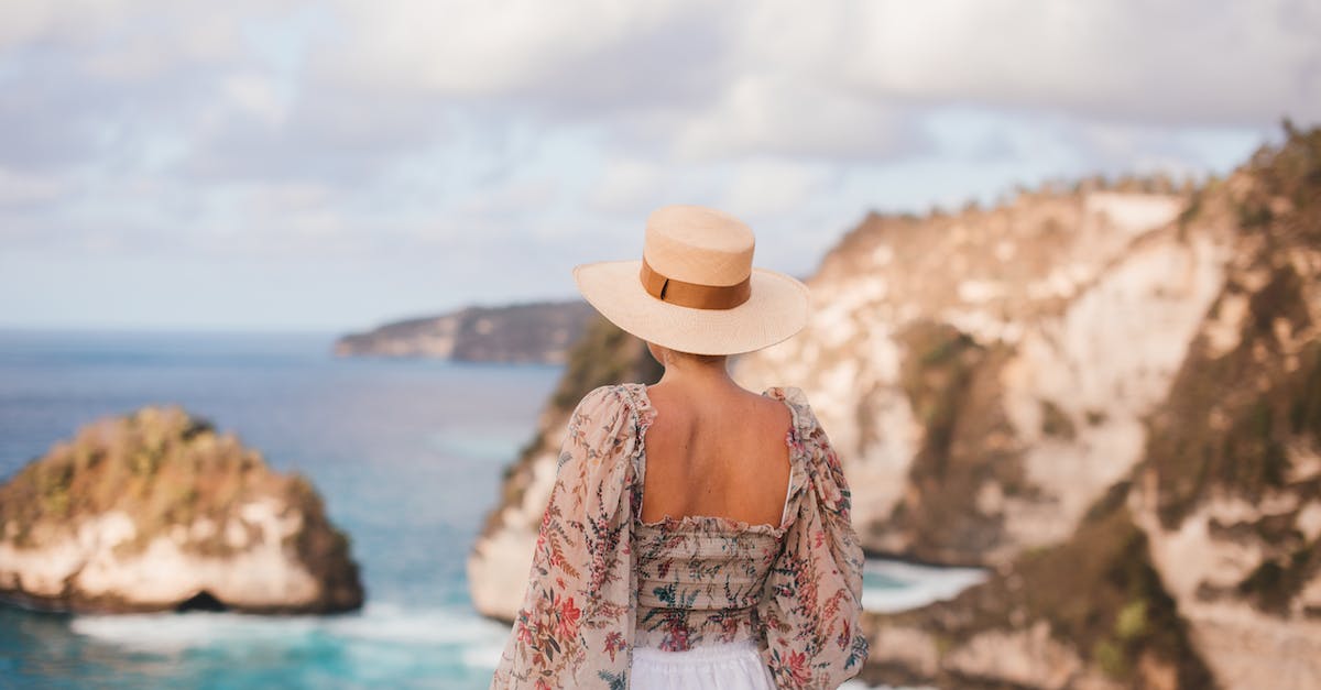 How to select the perfect travel hat [closed] - Trendy woman in hat admiring rocky cliffs