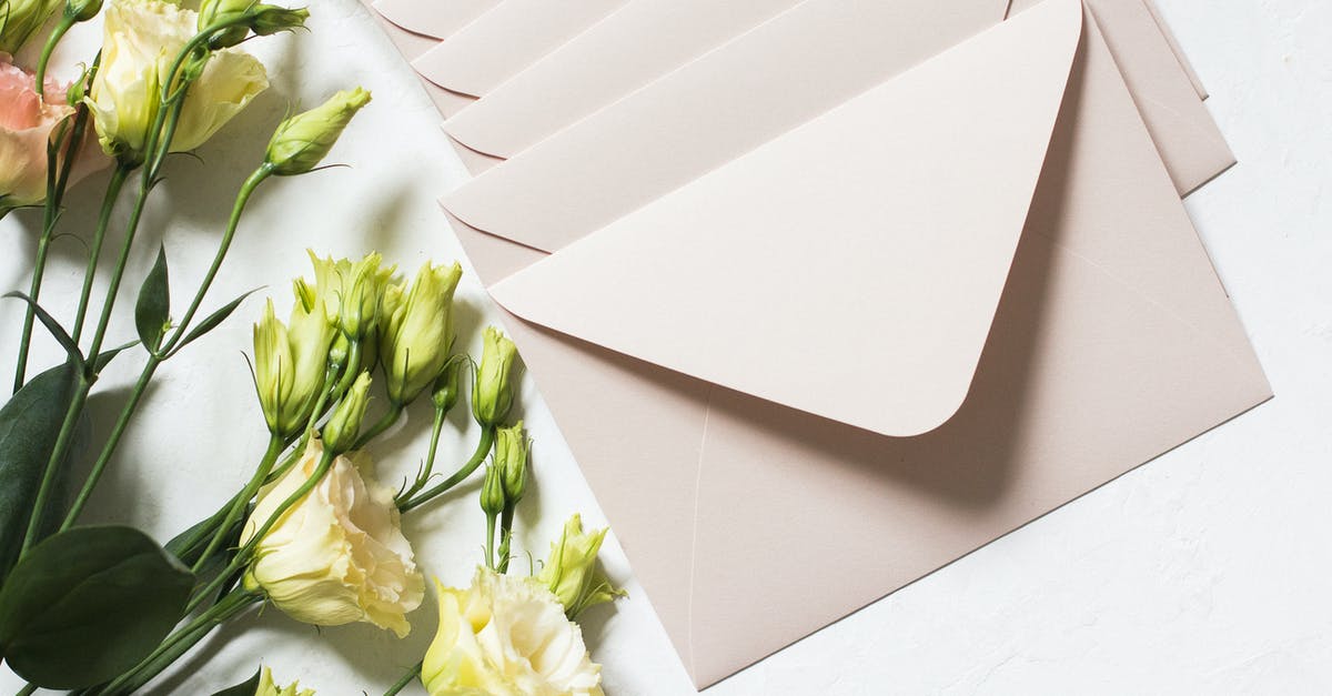 How to send an express letter from Turkey to Germany - From above of rows of light beige envelopes by white and pink delicate roses on stems with dark green leaves in daylight