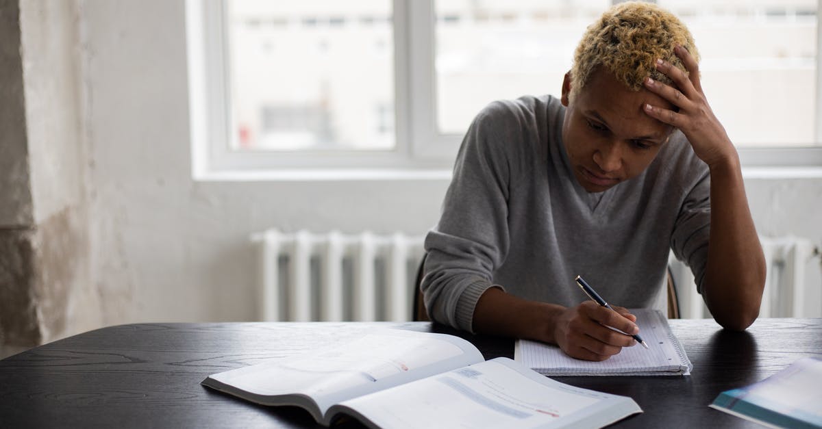 How to solve the language problem in Ankara, Turkey? - Wistful black man writing in notepad during lesson