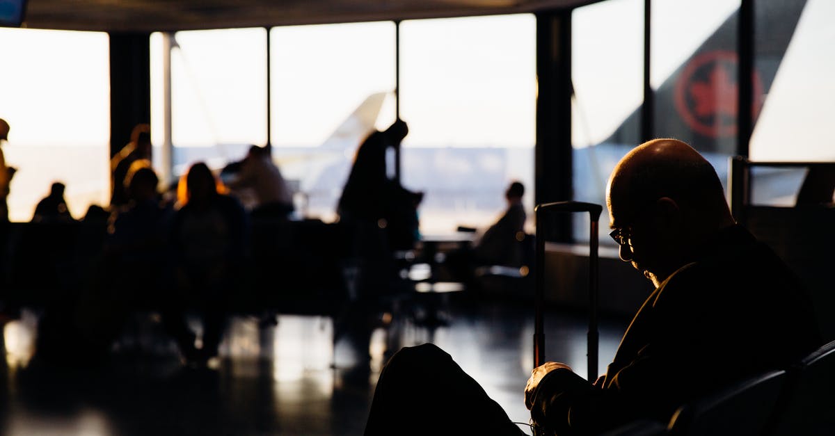 How to stay awake while waiting for a plane - Silhouette of People Sitting Waiting to Board