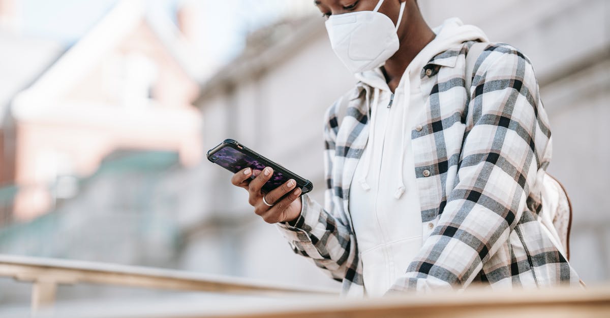 How to stay safe when using an autocaravan? - Black woman using smartphone on city street