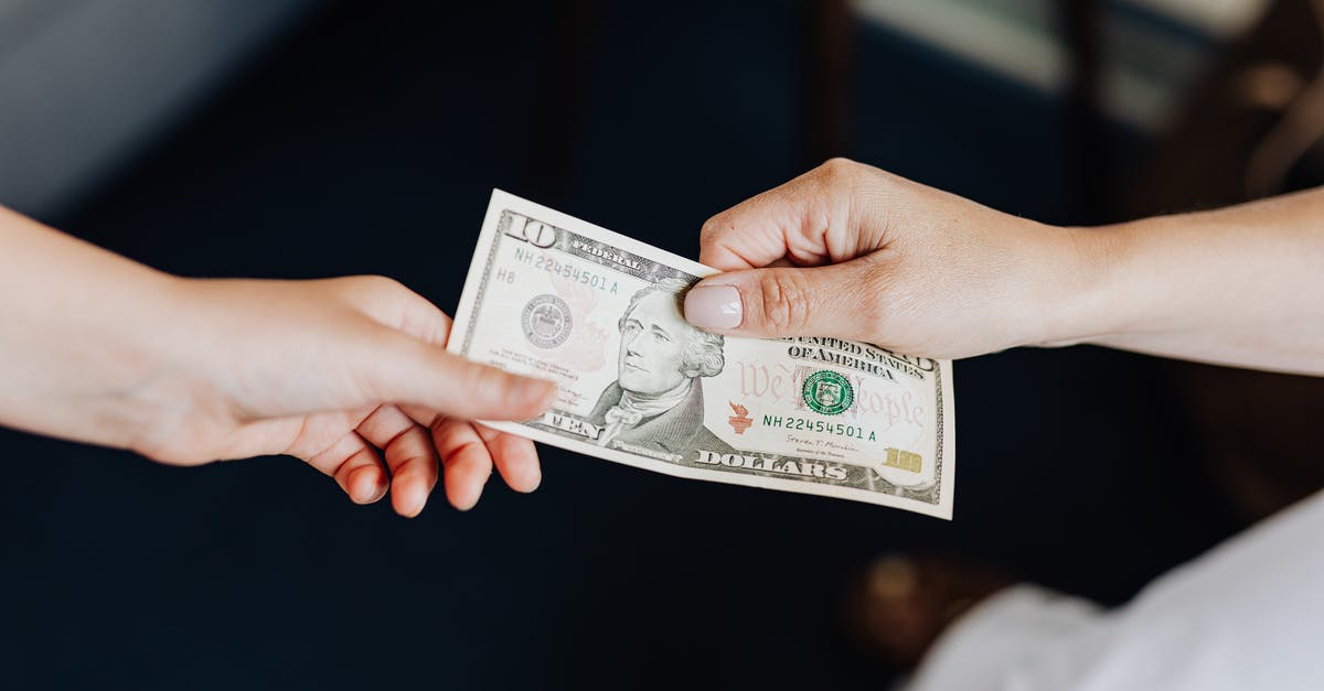 How to tip in Israel? - Hands Holding a 10 Dollar Bill