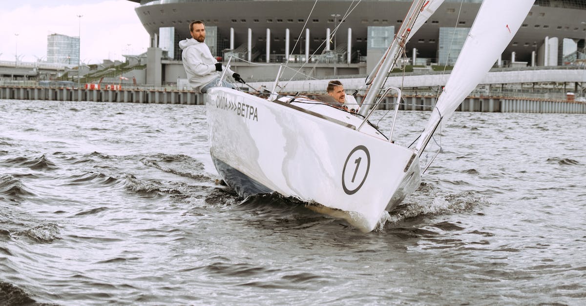 How to travel as a crew member on a ship? - Man in White T-shirt Standing on White Boat