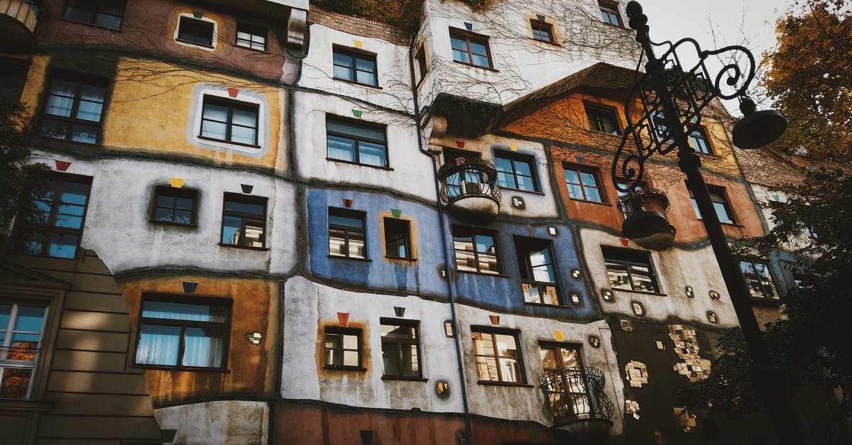 How to travel from Vienna airport to Győr - Facade of creative colorful apartment house in autumn city