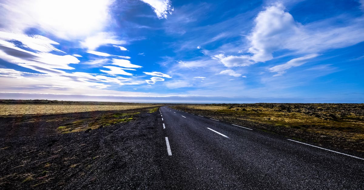 How to travel long distance in India during "Janatha Curfew"? - Black Asphalt Road Surrounded by Green Grass