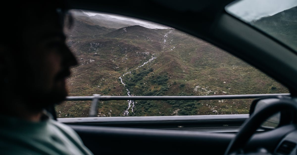 How to travel to Svalbard? [closed] - Person in White and Green Stripe Shirt Sitting on Car Seat