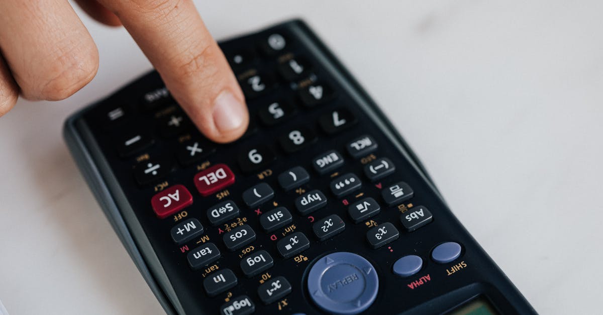 How to use dual flush button in toilet? - From above of crop anonymous economist calculating on calculator with plastic buttons while making budget on marble table