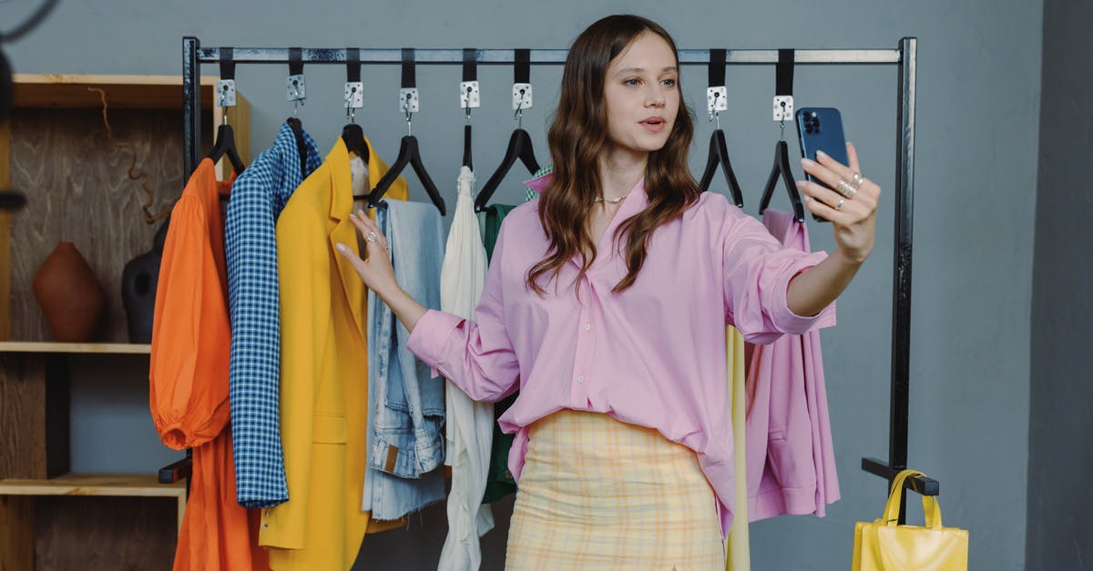 How to use eSIM abroad? [closed] - Woman in Pink Dress Shirt Standing Near Clothes Rack