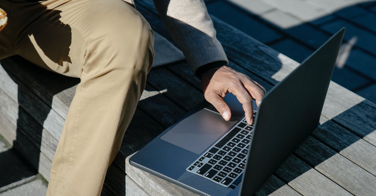 How to use eSIM abroad? [closed] - Person in Blue Long Sleeve Shirt and Brown Pants Using Macbook Pro