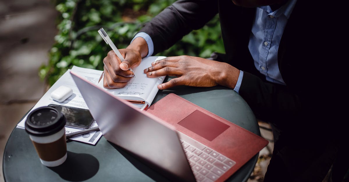 How to use USB decryption from Internet cafes? [closed] - From above of crop black male journalist in formal wear writing article while sitting at table with red laptop and cup of takeaway coffee