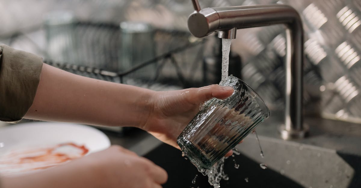 How to wash hands if tap water is too hot? - Person Pouring Water on Clear Drinking Glass