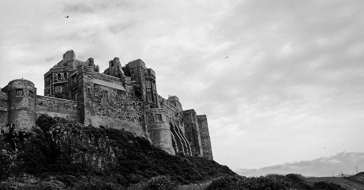 Huashan Cliffside Path: Accessible for tourists? - Grayscale Photo of Bamburgh Castle