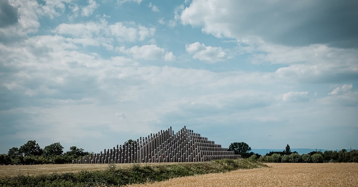 I'm a long-term resident of the Schengen area. Immigration at Frankfurt did not stamp my passport on arrival. Would this cause issues later on? - Picturesque view of pyramid in field with green and dry grass and trees on sunny day under cloudy sky