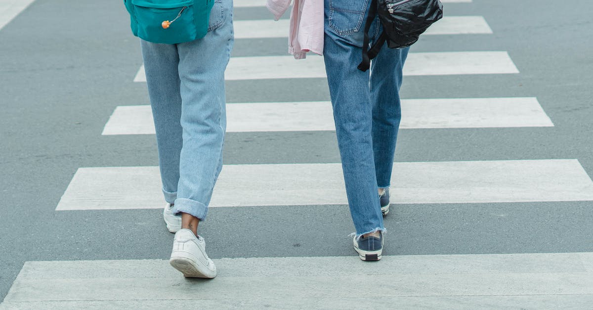 I'm an AU citizen living in Canada...how do I regularly visit my friend in the USA? - Unrecognizable women wearing jeans crossing city street