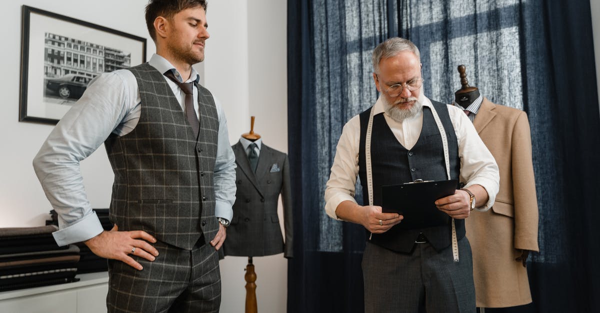 I'm worried about fitting into armrest [duplicate] - Man in Black Vest Standing Beside Man in Gray Suit